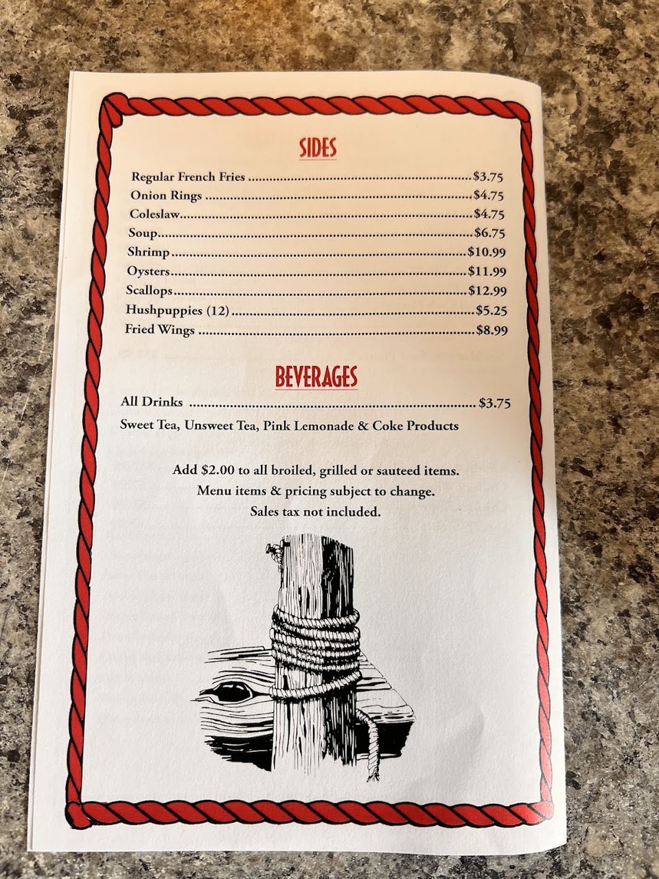 Printed menu showing fries, coleslaw, and shrimp.